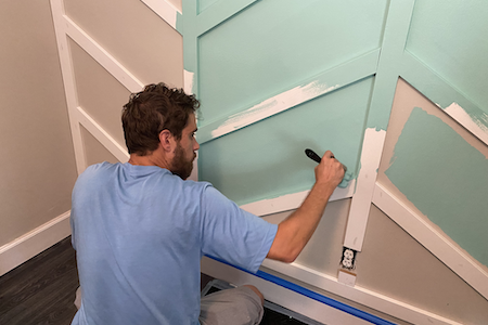 man painting an interior wall